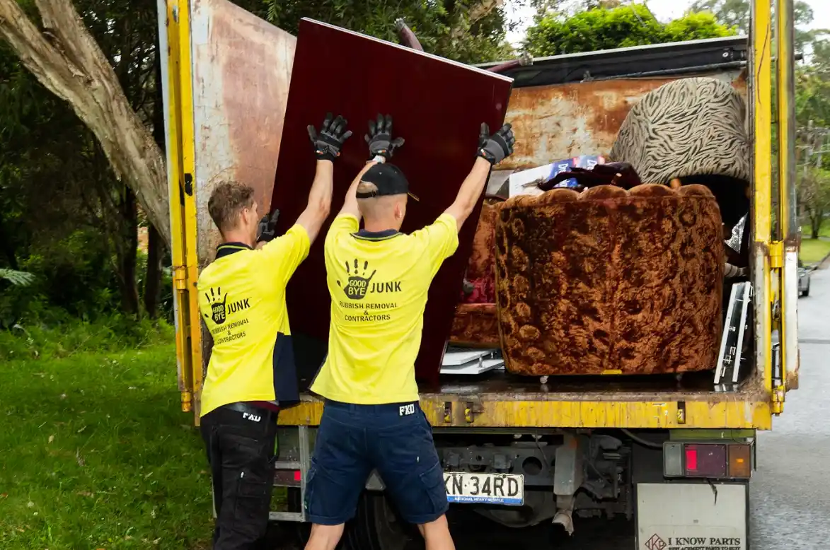Goodbye Junk Rubbish Removal contractors loading old sofa onto truck during deceased estate clearance