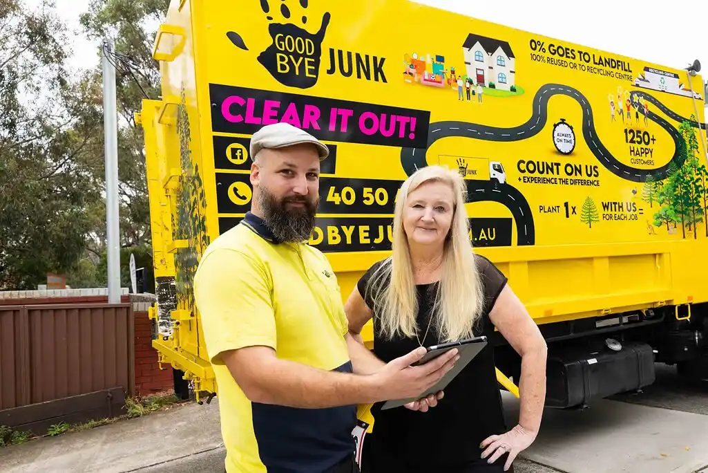 household-rubbish-removal-nsw-01 Goodbye Junk Rubbish Removal contractor and client reviewing household rubbish removal job details on tablet